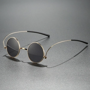 Retro 1960s hippie round sunglasses with gold metal frame and dark circular lenses