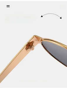Detail of durable textured hinge on gold metal sunglasses with reinforced screws