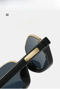 Detail of black and gold semi-rimless cat eye sunglasses with metal hinge structure
