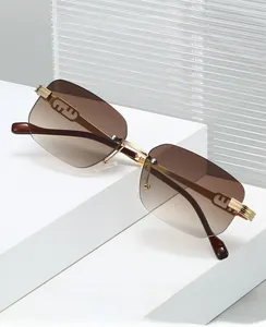 Close-up of frameless square sunglasses with brown gradient lenses and gold metal temples