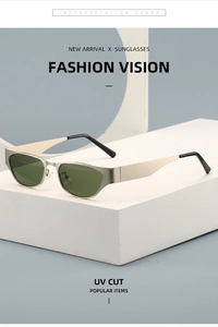 Detailed close-up of retro cat-eye sunglasses with champagne metal frame and green lenses