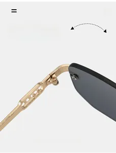 Detailed macro view of a durable golden metal hinge on square rimless sunglasses