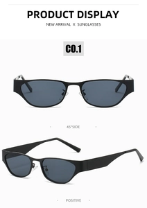 Detail view of narrow black cat-eye sunglasses featuring slim metal frames and dark lenses