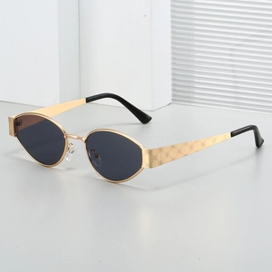 Retro oval metal sunglasses with rose floral engraving on gold frames and dark lenses