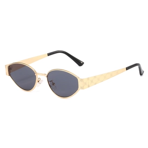 Vintage oval sunglasses with gold metal frame and embossed floral pattern temples