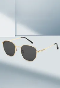 Detailed view of hexagonal sunglasses with gold metal temples and striped web accents