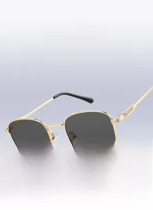 Detail of square gold metal sunglasses frame with grey lenses on purple background
