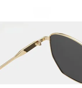 Detailed macro shot of sturdy gold metal hinges on stylish polygon sunglasses