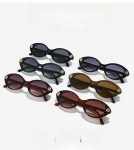 Detail of vintage oval sunglasses set with golden rose decorations on various frame colors