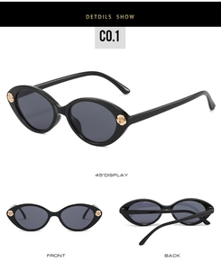 Detail view of black cat-eye sunglasses with golden 3D rose ornaments on the frame