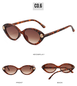 Detail view of tortoise shell sunglasses with gold rose floral hinge and gradient lens