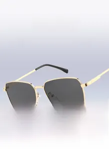 Close-up of retro oversized hexagonal sunglasses with gold metal frame and dark lenses