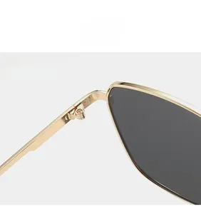 Close-up of durable golden metal hinge and sleek frame of vintage men sunglasses