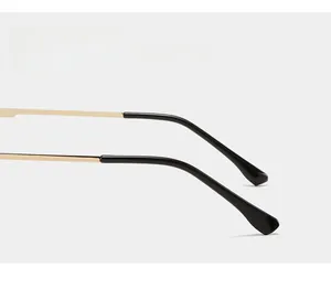 Macro view of golden metal temple arms with black curved anti-slip tips for extra comfort