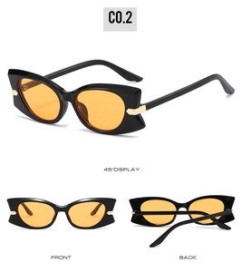 Détail de lunettes de soleil papillon avec verres orange et accents en métal doré chic