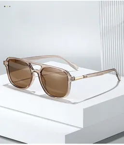 Detail view of tea-colored transparent resin frames and metal hinges on pilot sunglasses