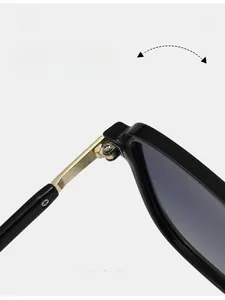 Detail of durable texture hinge on black frame sunglasses with gold-tone alloy hardware