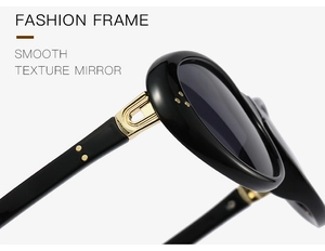 Detailansicht der ovalen schwarzen Sonnenbrille mit goldenen Scharnieren und Nieten