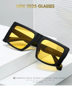 Detail view of large square black frame glasses with yellow lenses and hinge quality