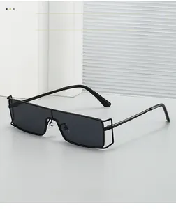 Detail of black metal sunglasses featuring hollow geometric hinge and textured material