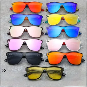 Flat lay of colorful oversized rimless sunglasses in eleven vibrant shades for fashion