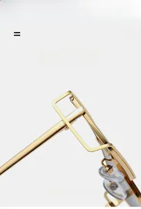 Close-up of golden metal hinge and temple detail on minimalist oversized sunglasses