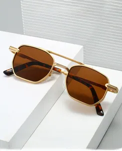 Detail of square gold metal sunglasses frame with double bridge and brown lenses