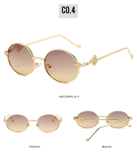 Detail of oval vintage sunglasses with gold frames and snake textured metal temple hinges