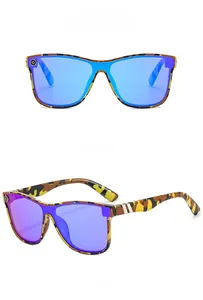 Flat lay of oversized camouflage sunglasses with icy blue mirrored lens finish