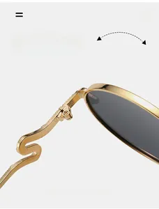 Detail of durable reinforced metal hinge and gold S-curve temple on sunglasses