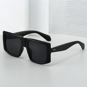 Modern oversized square sunglasses in glossy black frame with wide rivet temples