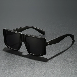 Fashionable oversized square black sunglasses with silver rivet accents and dark lenses