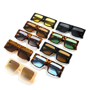 Multiple colorful square oversized Y2K sunglasses in black and tortoiseshell on white surface