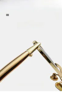 Close-up of lightweight elastic metal hinges on gold oval fashion sunglasses