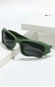 Detail view of matte olive green tactical sport sunglasses with streamlined wide frames
