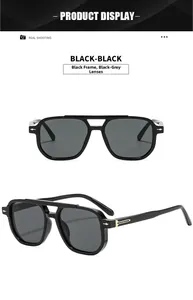 Macro detail of black frame sunglasses with golden arrow accents and grey UV lenses