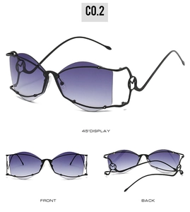 Détail de lunettes de soleil papillon irrégulières avec branches évidées en M et verres dégradés