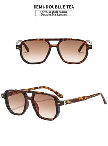 Detailed view of tortoise shell double bridge sunglasses with brown gradient lenses