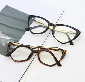 Detail of cat-eye frames in black and tortoise shell with slim golden metal temples
