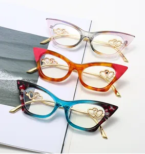 Close-up of cat-eye glasses frames with hollow heart metal temples in various patterns