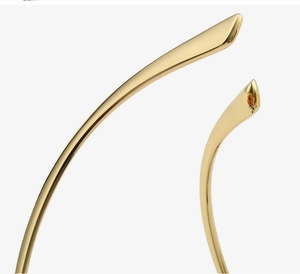 Macro shot of polished gold cat-eye glasses frame with smooth tapered metal temple tips