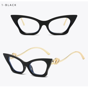 Detail of black cat-eye glasses frame featuring gold metal temples and double heart cutouts