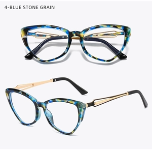 Macro detail of cat eye glasses with blue stone grain texture and gold metal temples