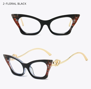 Detail of floral black cat-eye glasses frame with golden heart-shaped hollow temple hinges