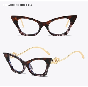 Detail of tortoiseshell cat-eye glasses with gold metal temples and heart accents