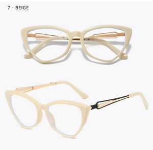Macro shot of beige cat-eye glasses frame with gold metal hinges on a white background