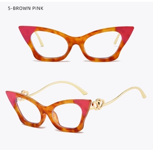 Detail of cat-eye frames with hollow double-heart pattern on golden metal temples