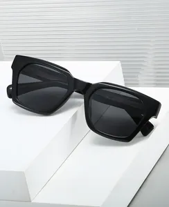 Detail of square black sunglasses on white geometric pedestal with modern frame texture