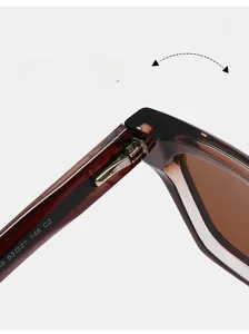 Close-up of durable metal hinge on dark brown tortoiseshell sunglasses with brown lenses