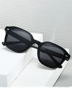 Detail view of 2025 black hexagonal sunglasses with silver rivets and grey lenses